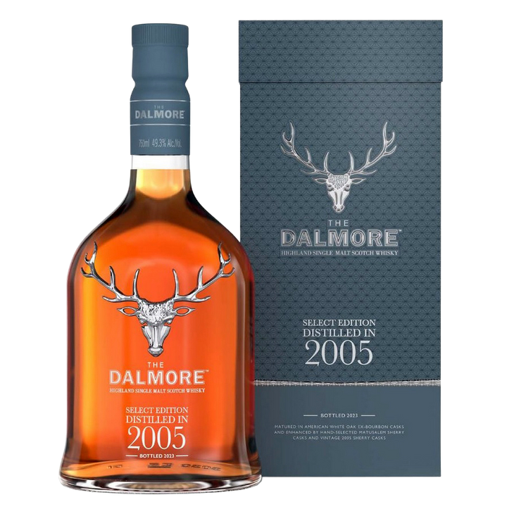 A bottle of The Dalmore 18 Year Old 2005 Vintage Single Malt Whisky stands beside its gray box with a silver stag logo and embossed text, displaying amber liquid inside.