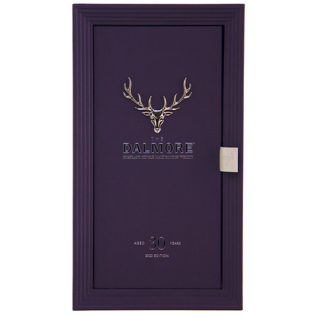 A rectangular purple box features a silver stag head logo and “The Dalmore” at center. Below, it states “30 Year Old Highland Single Malt, 2023 Edition.” The textured box with side tab holds this luxury whisky.