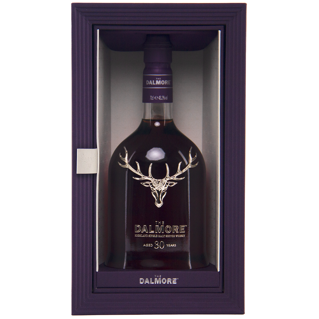 A bottle of The Dalmore 30 Year Old Single Malt Scotch with a silver stag logo, presented in a purple box featuring a clear front panel.