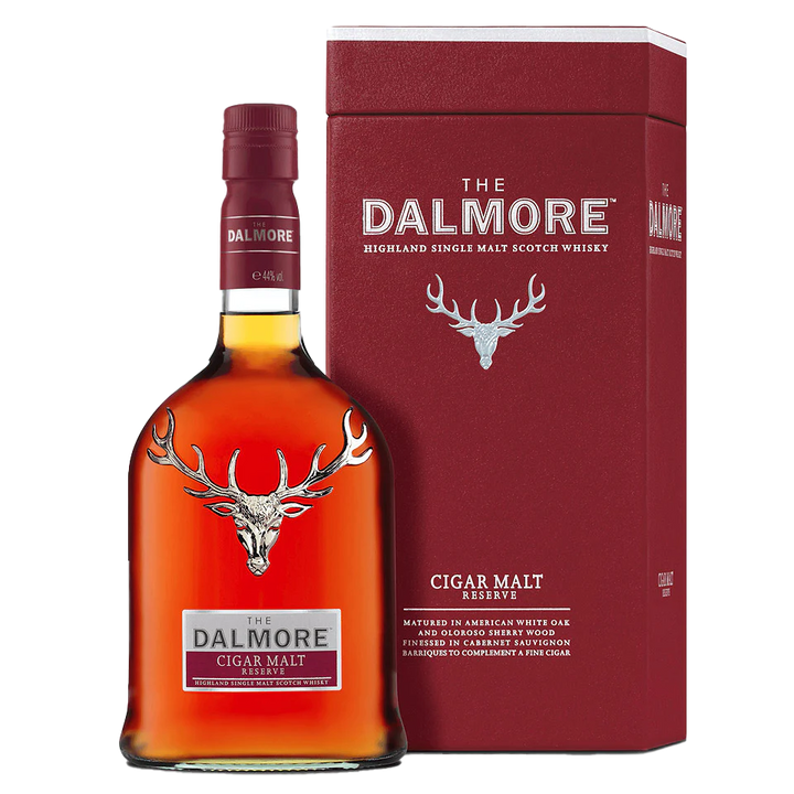 A bottle of The Dalmore Cigar Malt Reserve Single Malt Scotch Whisky stands beside its maroon box, both adorned with a silver stag logo and white text—ideal for pairing with a fine cigar.
