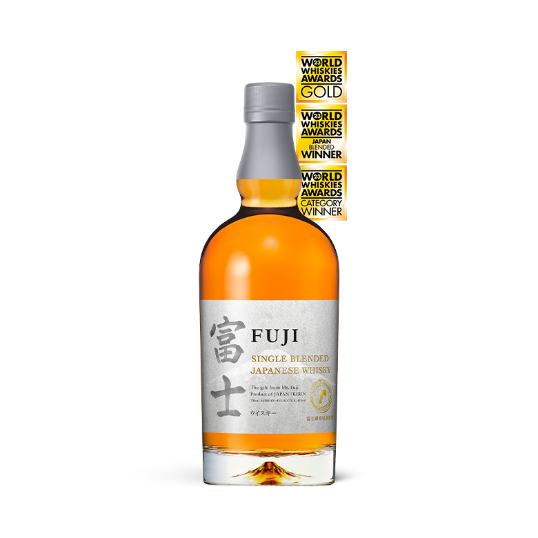 A bottle of Fuji Single Blended Japanese Whisky, featuring a grey and silver label with Japanese characters and three gold award stickers vertically stacked on the upper right.