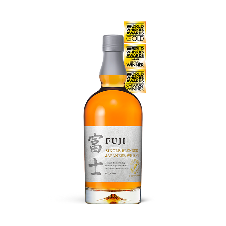 A bottle of Fuji Single Blended Japanese Whisky, featuring a grey and silver label with Japanese characters and three gold award stickers vertically stacked on the upper right.