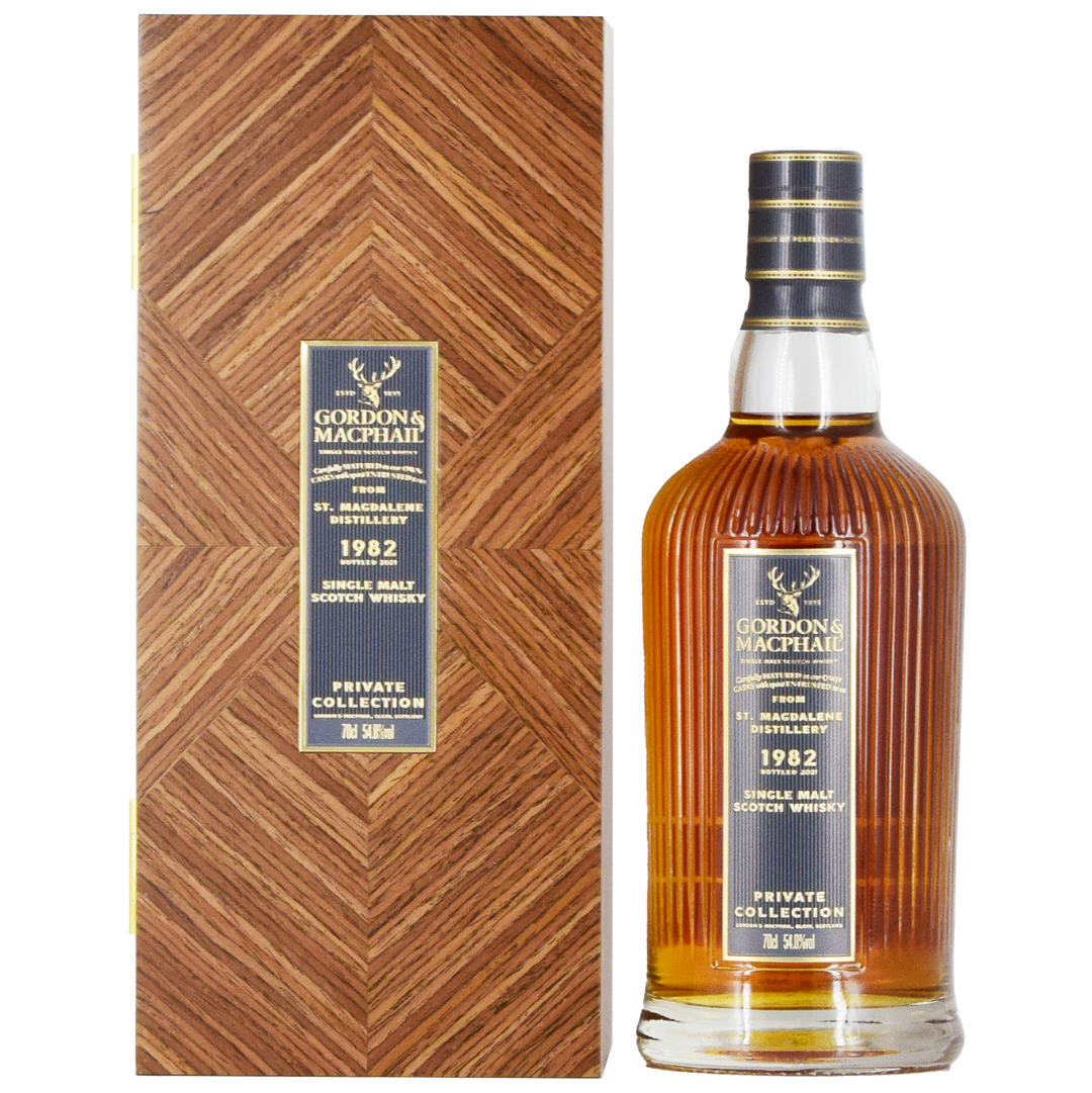 A bottle of Gordon & MacPhail St. Magdalene 1982 39 Year Old Single Malt Scotch Whisky 700ml stands beside its matching wood-patterned box, both adorned with dark blue and gold labels.