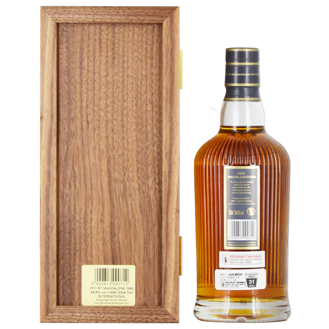 A bottle of Gordon & MacPhail St. Magdalene 1982 39 Year Old Single Malt Scotch Whisky 700ml with a black and gold striped cap stands upright next to its wooden box, product details visible on the back label, against a white background.
