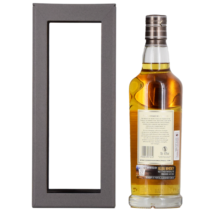A bottle of Gordon & MacPhail Tomatin 1990 28 Year Old Single Malt Scotch Whisky 700ml with a silver cap stands beside a black gift box with a large transparent window, showing the whisky label and the back of the box.