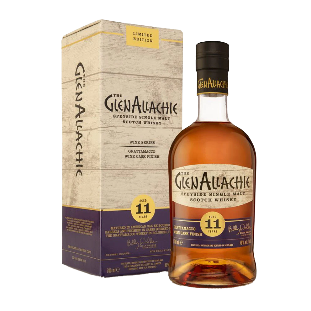 A bottle of GlenAllachie 11 Year Old Grattamacco Cask Finish Single Malt Scotch Whisky stands next to its matching "Limited Edition" box, both adorned with cream, purple, and gold accents.