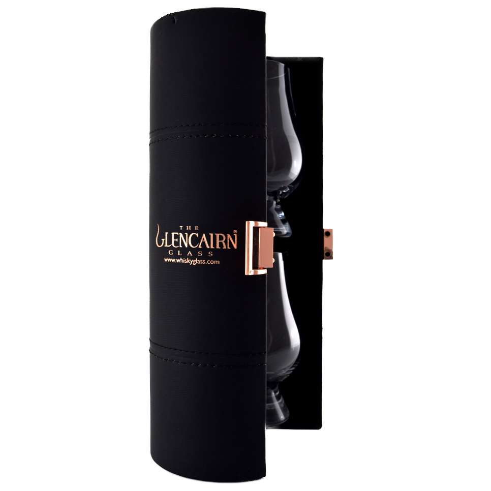 A black cylindrical travel case with gold "The Glencairn Glass" lettering and a copper latch holds two Glencairn Original Crystal Whisky Glasses—ideal for whisky tasting wherever you go.