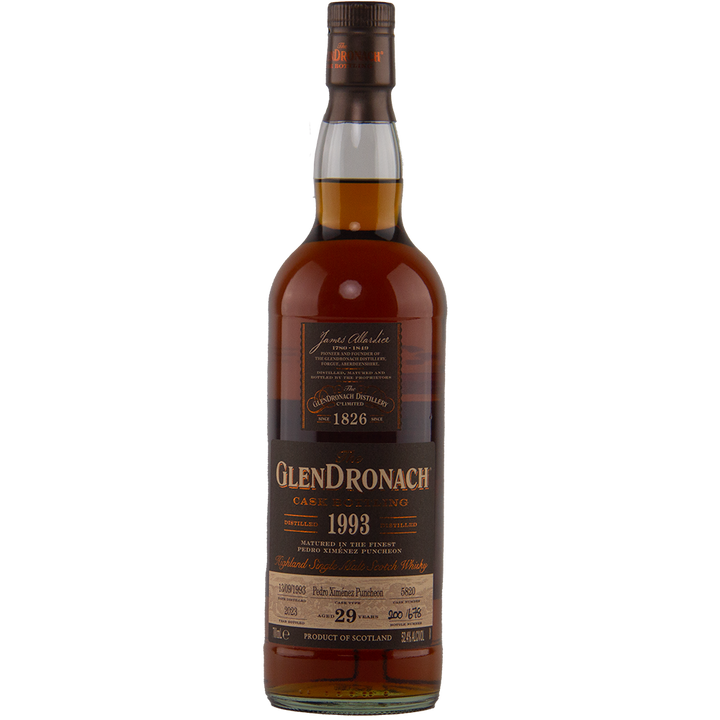 A bottle of Glendronach 1993 29 Year Old, single cask release, with a dark brown label showing "Case Serving, 1993 cask bottling, 29 years old" and distillery details; features a rich amber hue.