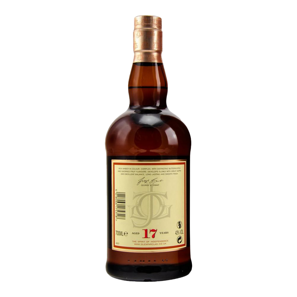 A bottle of Glenfarclas 17 year old Single Malt Scotch Whisky features a copper cap, amber liquid, and a cream back label with text, signature, and the red number 17, marking its sherry cask maturation for 17 years.
