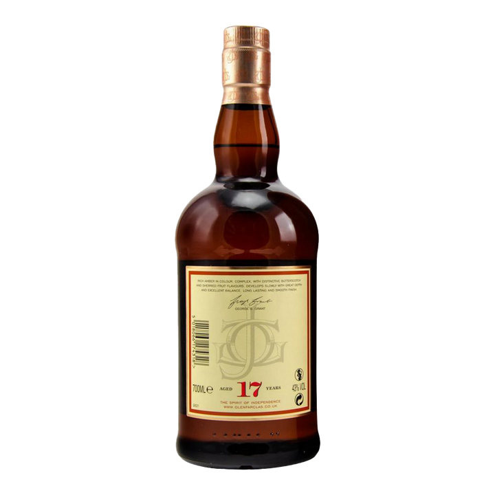 A bottle of Glenfarclas 17 year old Single Malt Scotch Whisky features a copper cap, amber liquid, and a cream back label with text, signature, and the red number 17, marking its sherry cask maturation for 17 years.