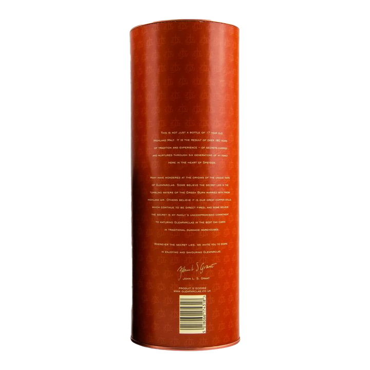 A tall, cylindrical orange container with gold text and a signature is shown from the back. This is Glenfarclas 17 year old Single Malt Scotch Whisky, featuring small white writing near the bottom against a plain white background.