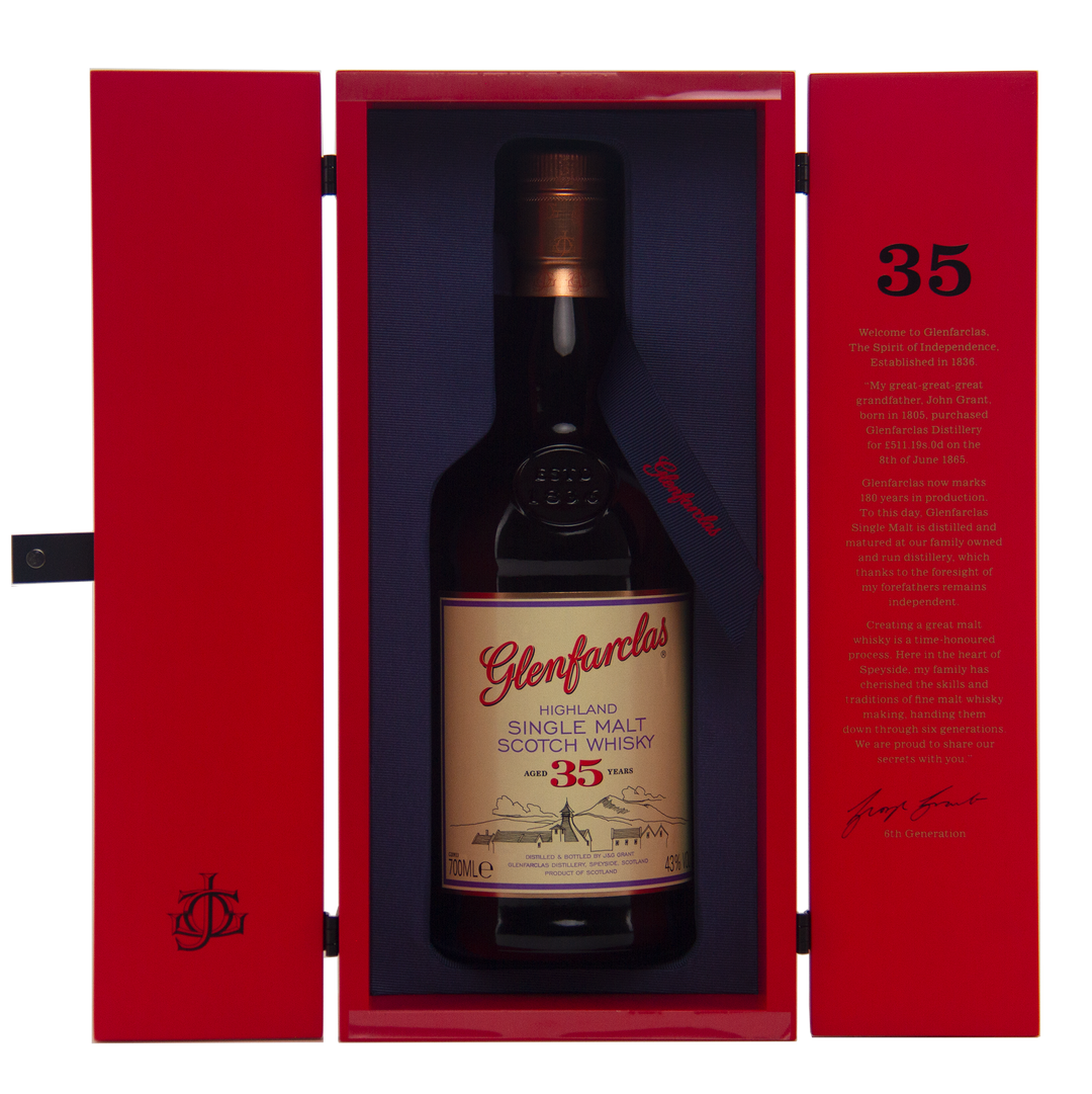 A bottle of Glenfarclas 35 Year Old Single Malt Scotch Whisky, matured in sherry casks, is presented in an open red box with a gold and white label, alongside printed text on the inner lid.