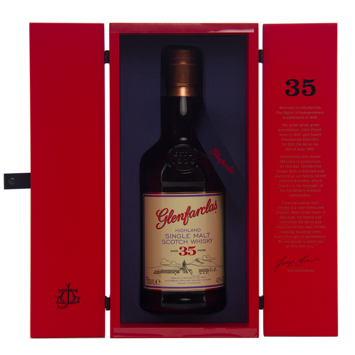 A bottle of Glenfarclas 35 Year Old Single Malt Scotch Whisky, matured in sherry casks, is presented in an open red box with a gold and white label, alongside printed text on the inner lid.