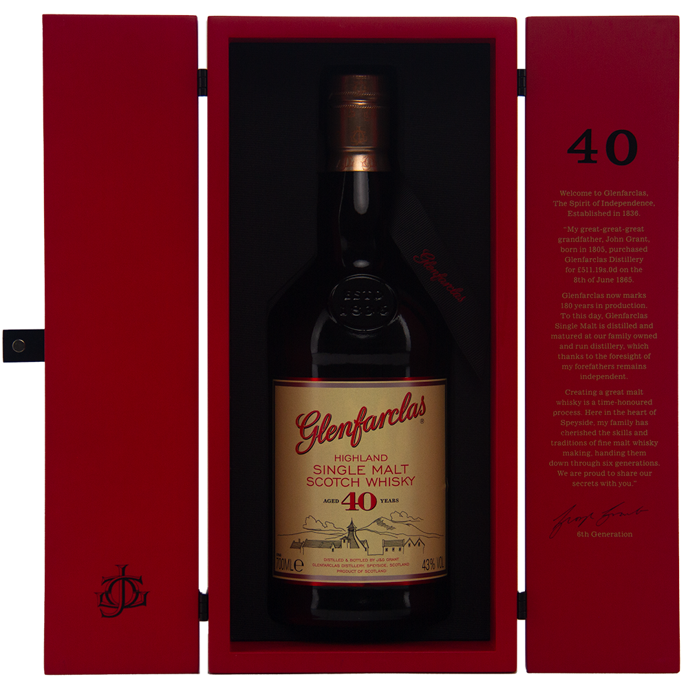 A bottle of Glenfarclas 40 year old Single Malt Scotch Whisky in an open red presentation box, with gold and red labels and gold text inside the cover detailing its rich sherried notes.