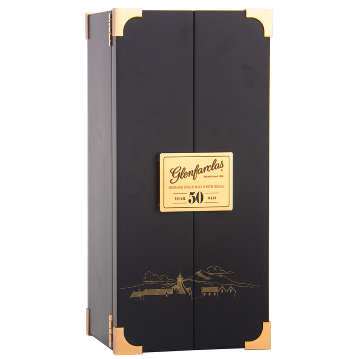 A tall, rectangular black box with gold accents and a plaque reading "Glenfarclas 50 year old Single Malt Scotch Whisky." A gold landscape illustration on the front emphasizes this iconic Highland whisky’s esteemed heritage.