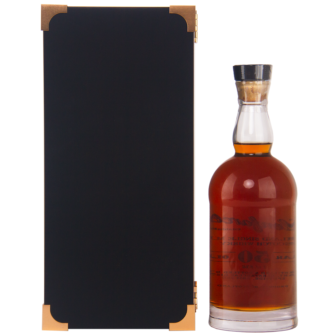 A bottle of Glenfarclas 50 year old Single Malt Scotch Whisky with a clear glass stopper stands beside a tall, rectangular black box with gold corner accents, both set against a white background.
