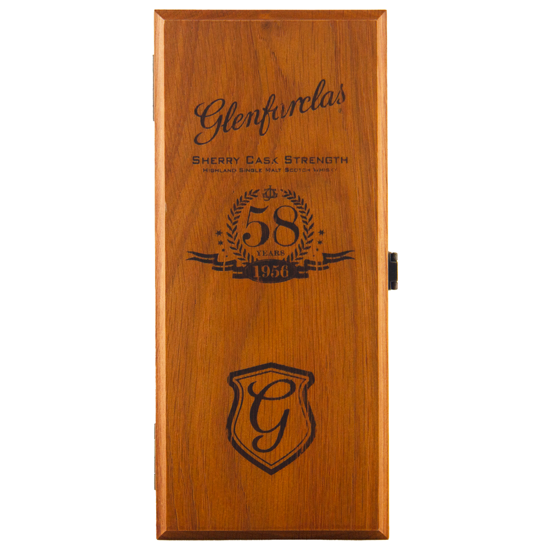 A wooden box lid engraved with the Glenfarclas logo, a stylized G crest, "Sherry Cask Strength," and "Glenfarclas 1956 58 Year Old" inside a laurel wreath.