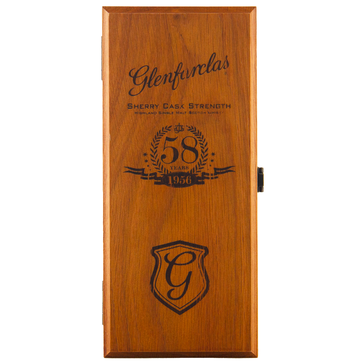 A wooden box lid engraved with the Glenfarclas logo, a stylized G crest, "Sherry Cask Strength," and "Glenfarclas 1956 58 Year Old" inside a laurel wreath.