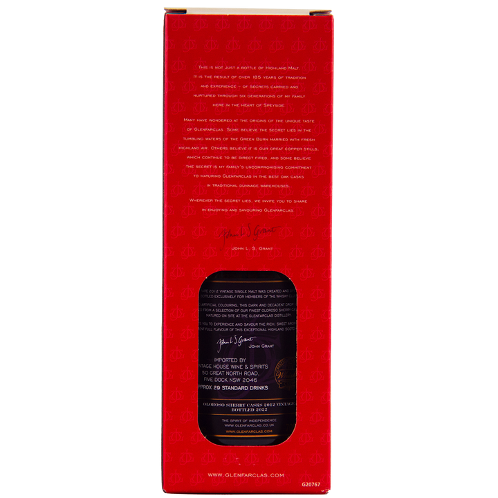 A red box with a cut-out window displays the Glenfarclas Oloroso Sherry Casks 2012 Vintage bottle. Gold and white text, a signature, and subtle patterns accentuate this Speyside single malt whisky packaging.