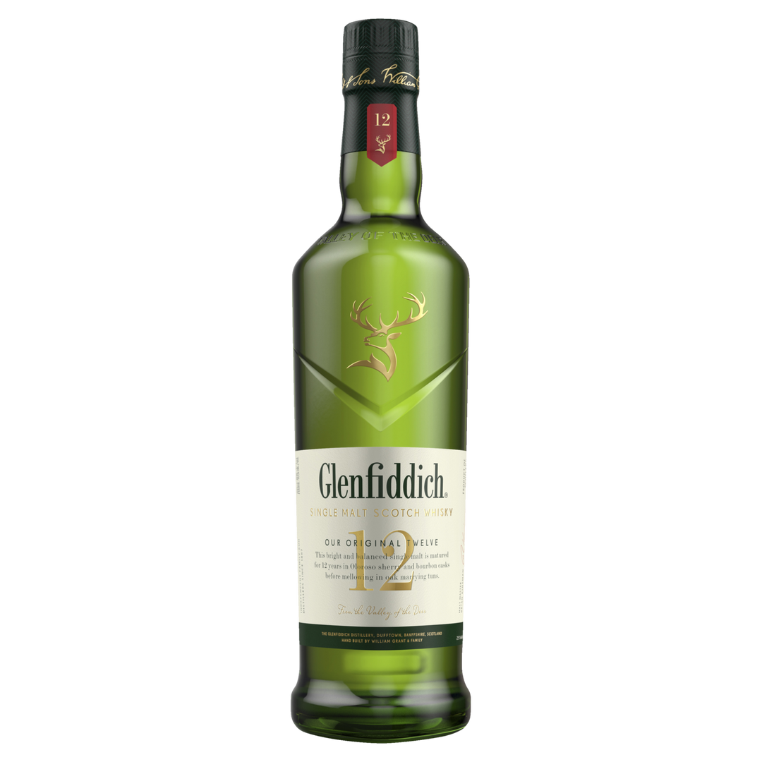 A green bottle of Glenfiddich 12 Year Old Single Malt Scotch Whisky with a gold stag logo and cream label stands upright on a white background, representing this classic Speyside whisky known for its smooth, distinctive flavor.