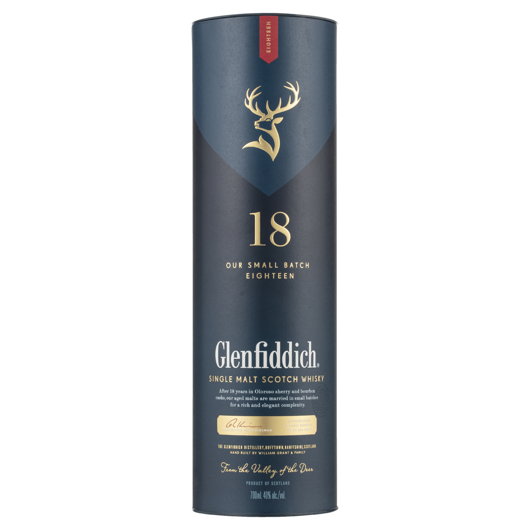 A tall, cylindrical dark blue box with gold and white lettering for Glenfiddich 18 Year Old Single Malt Scotch Whisky, featuring a gold stag logo and a red accent at the top.