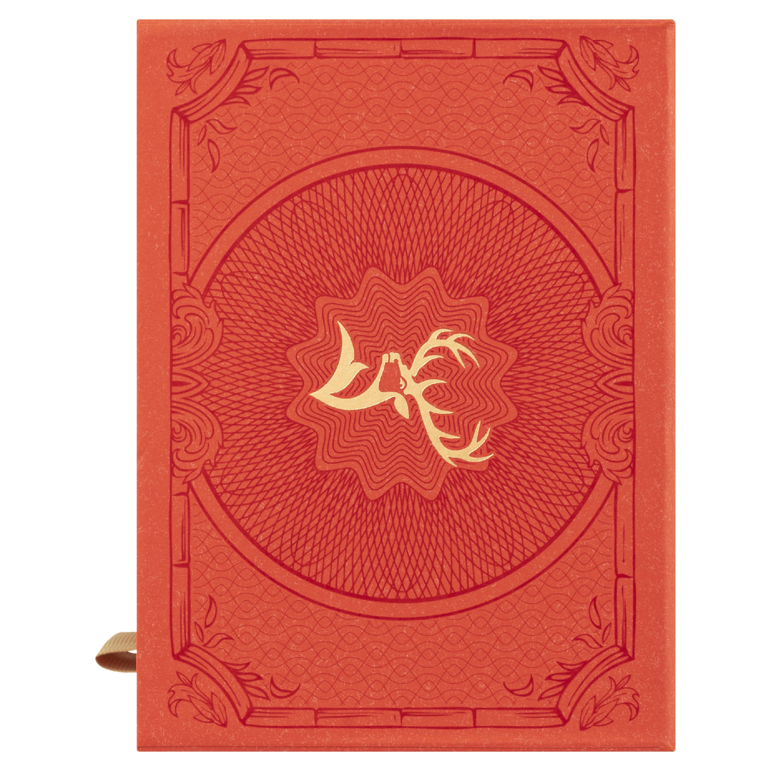 A red journal inspired by Glenfiddich 21 Year Old Gran Reserva Single Malt Scotch Whisky, featuring a gold antler design at the center, ornate border details on the cover, and a brown ribbon bookmark visible on the left.