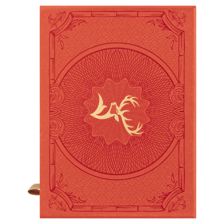 A red journal inspired by Glenfiddich 21 Year Old Gran Reserva Single Malt Scotch Whisky, featuring a gold antler design at the center, ornate border details on the cover, and a brown ribbon bookmark visible on the left.