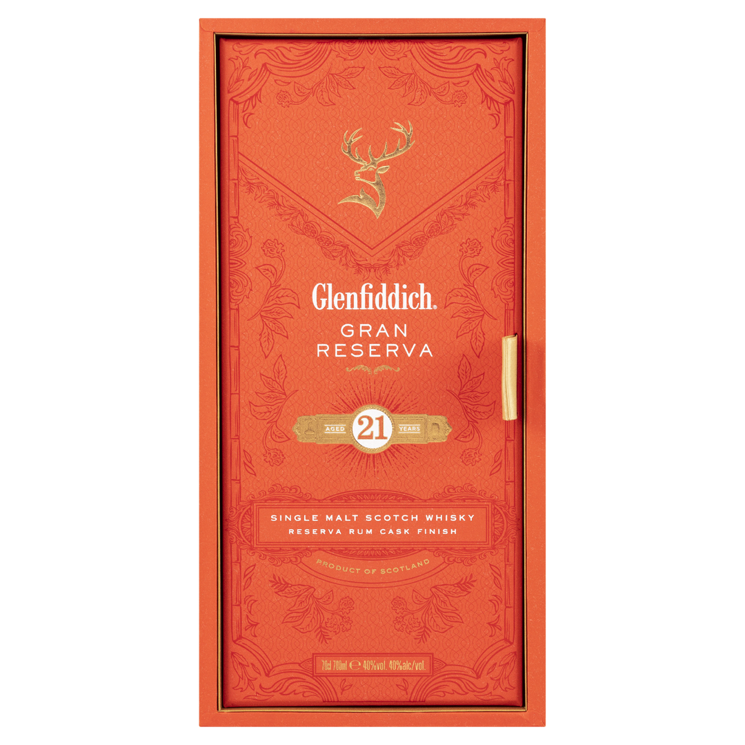 Front view of the orange Glenfiddich 21 Year Old Gran Reserva Single Malt Scotch Whisky box, adorned with gold text, a stag emblem, and elegant patterns, highlighting its distinctive Caribbean rum cask finish.