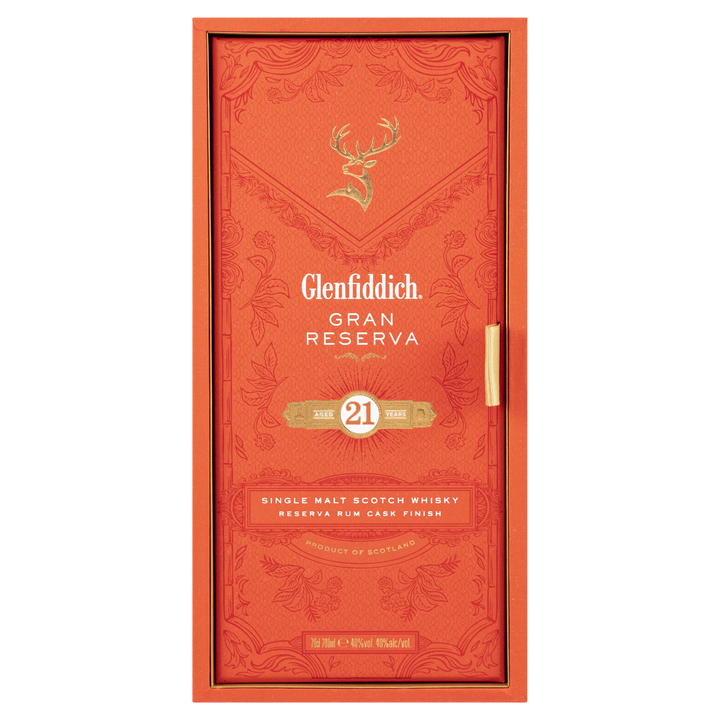 Front view of the orange Glenfiddich 21 Year Old Gran Reserva Single Malt Scotch Whisky box, adorned with gold text, a stag emblem, and elegant patterns, highlighting its distinctive Caribbean rum cask finish.