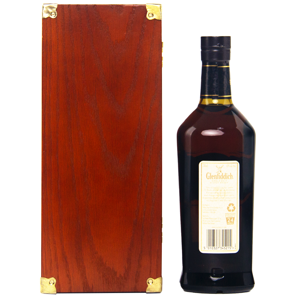 A dark brown bottle of Glenfiddich 30 Year Old Single Malt Scotch Whisky with a cream label stands beside a rectangular wooden box with gold metal corners, both set against a white background.