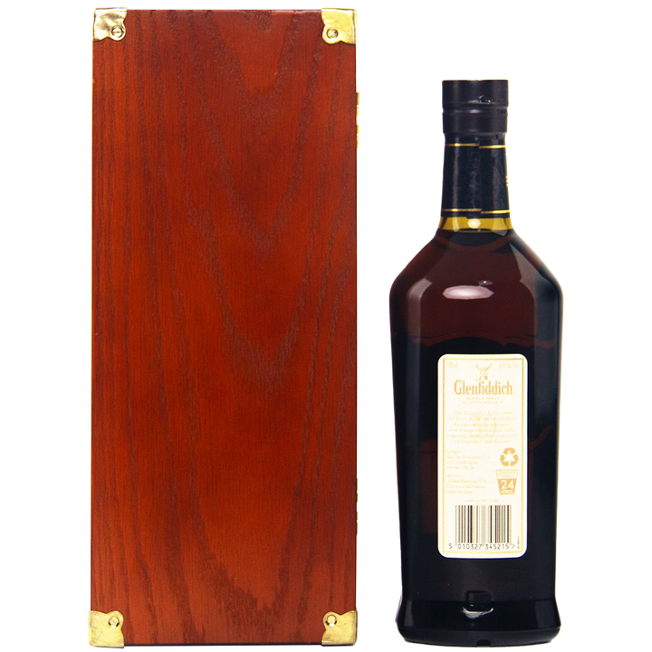 A dark brown bottle of Glenfiddich 30 Year Old Single Malt Scotch Whisky with a cream label stands beside a rectangular wooden box with gold metal corners, both set against a white background.