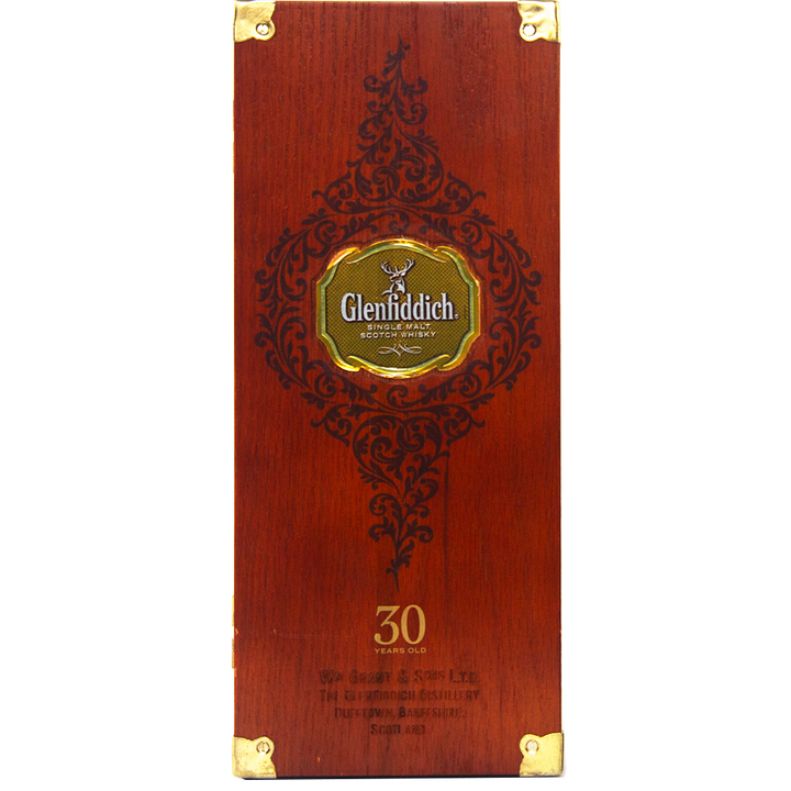 A rectangular wooden box with gold accents and ornate black designs, featuring the Glenfiddich 30 Year Old Single Malt Scotch Whisky logo in the center and “30 Years Old” displayed near the bottom.