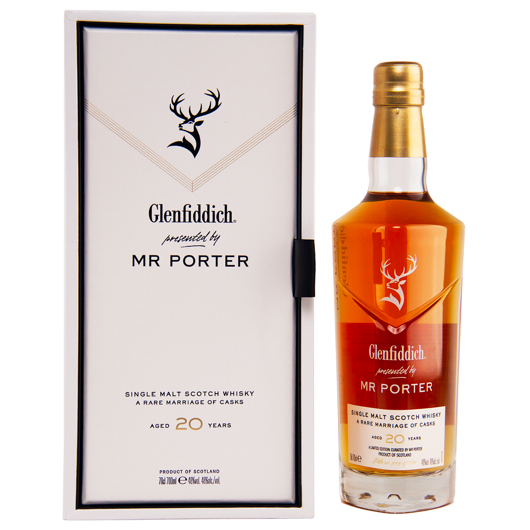 The Glenfiddich Mr. Porter 20 Year Old Single Malt Scotch Whisky stands next to its sleek white and black box featuring the Glenfiddich logo and branding.