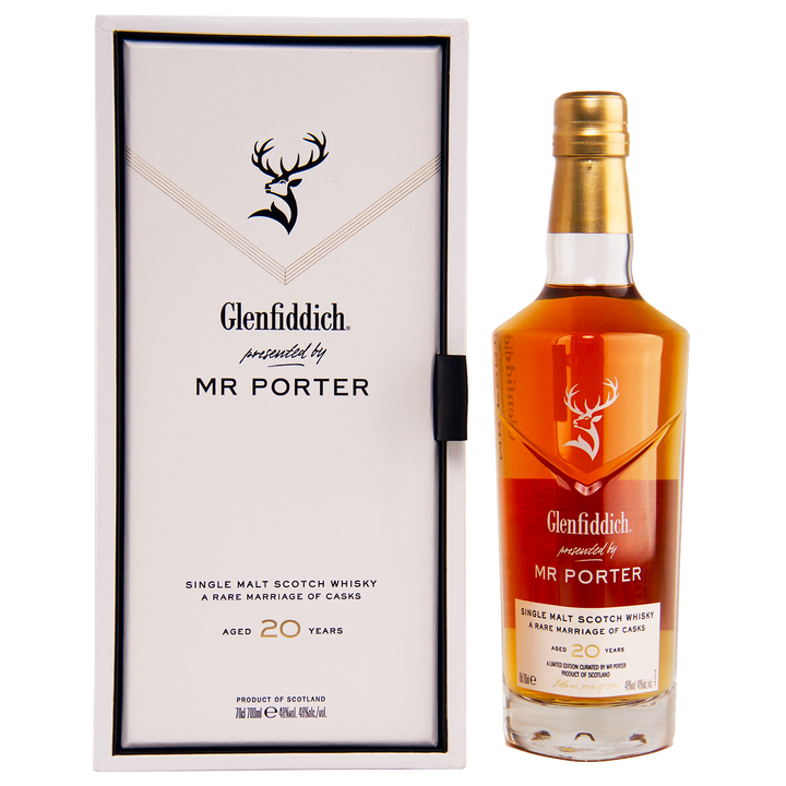 The Glenfiddich Mr. Porter 20 Year Old Single Malt Scotch Whisky stands next to its sleek white and black box featuring the Glenfiddich logo and branding.