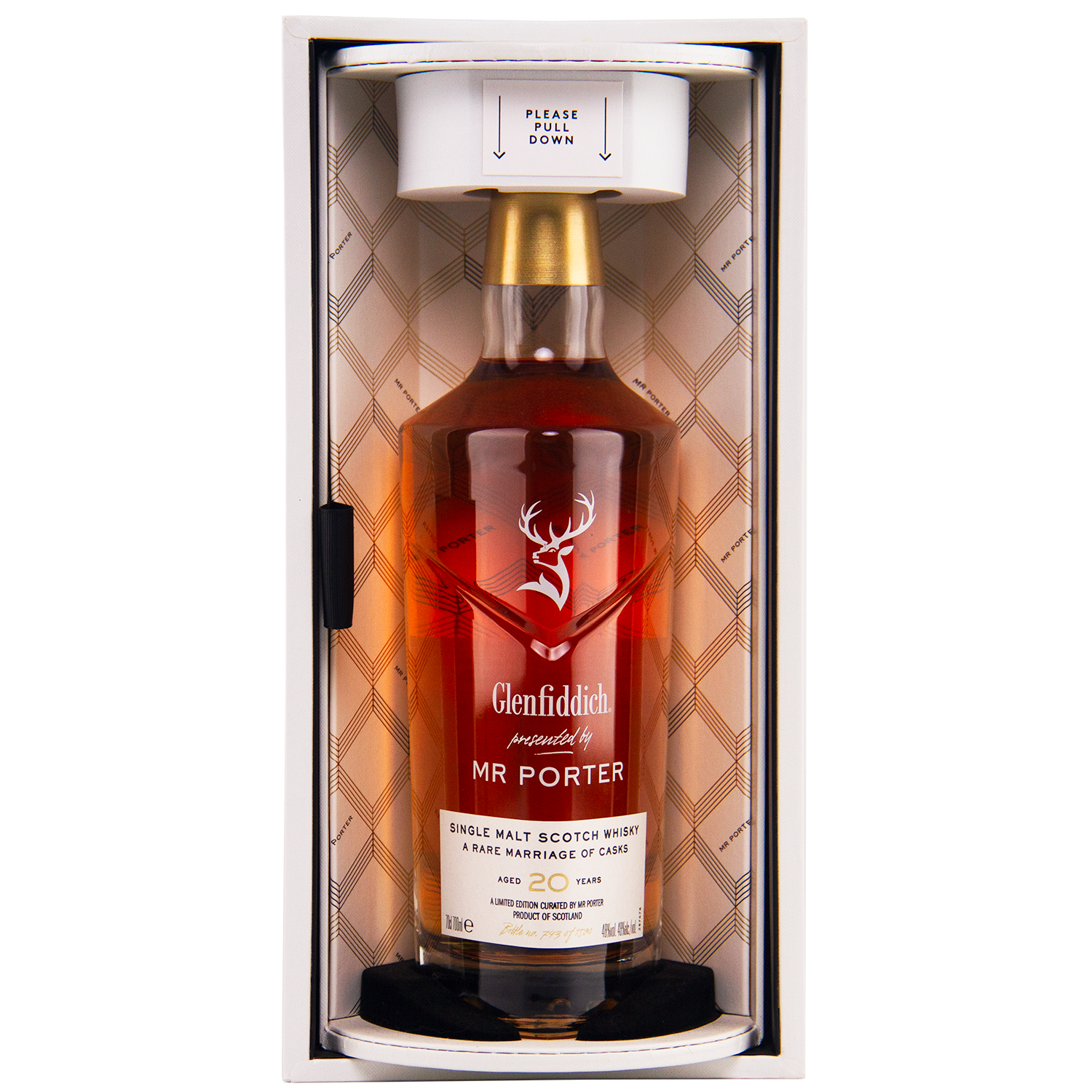 A bottle of Glenfiddich Mr. Porter 20 Year Old Single Malt Scotch Whisky stands upright in an elegant box with a plaid-patterned interior and a “PLEASE PULL DOWN” note, celebrating this exclusive MR PORTER collaboration.