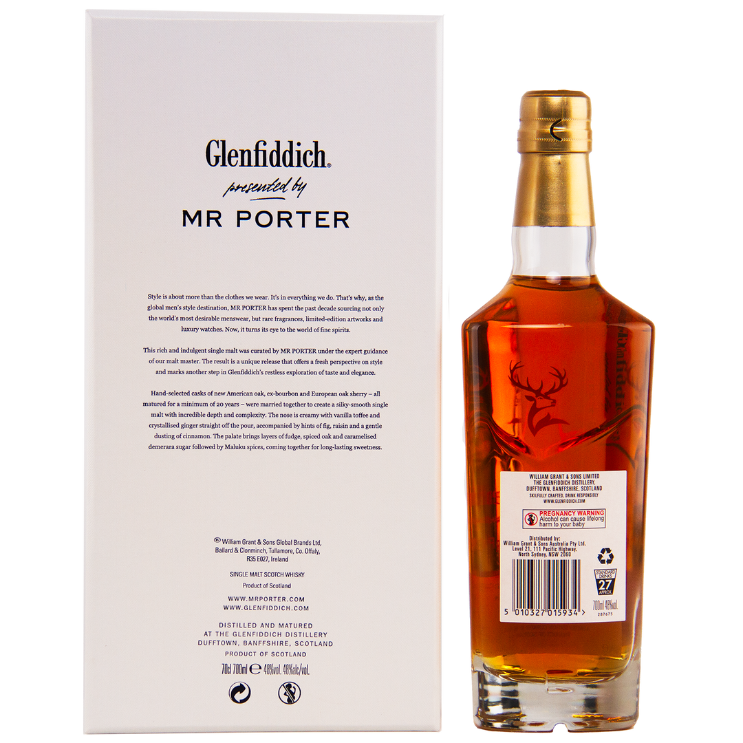 A bottle of Glenfiddich Mr. Porter 20 Year Old Single Malt Scotch Whisky, featuring a deer emblem on the label, stands next to its white box with black text highlighting the MR PORTER collaboration.