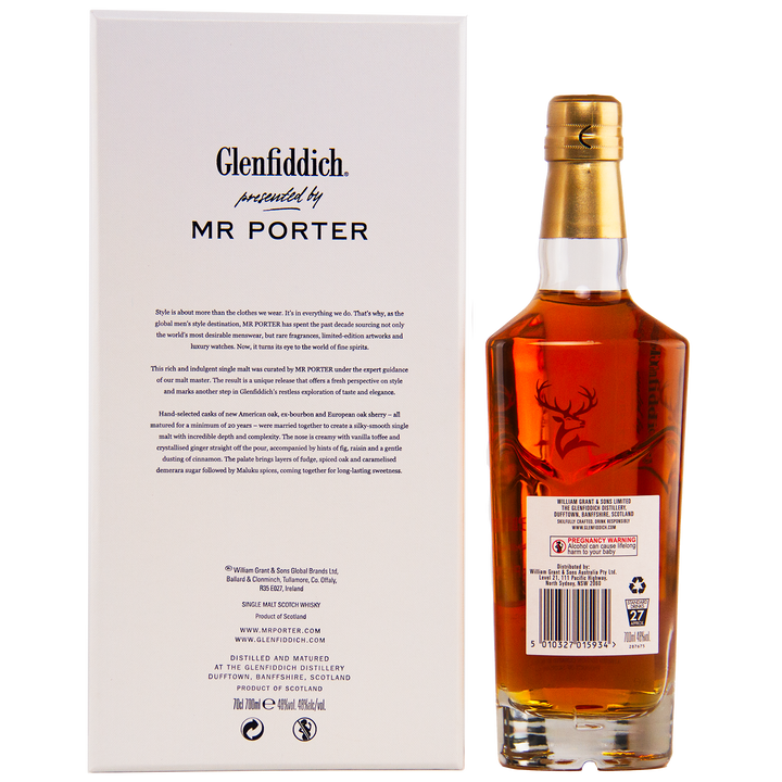A bottle of Glenfiddich Mr. Porter 20 Year Old Single Malt Scotch Whisky, featuring a deer emblem on the label, stands next to its white box with black text highlighting the MR PORTER collaboration.