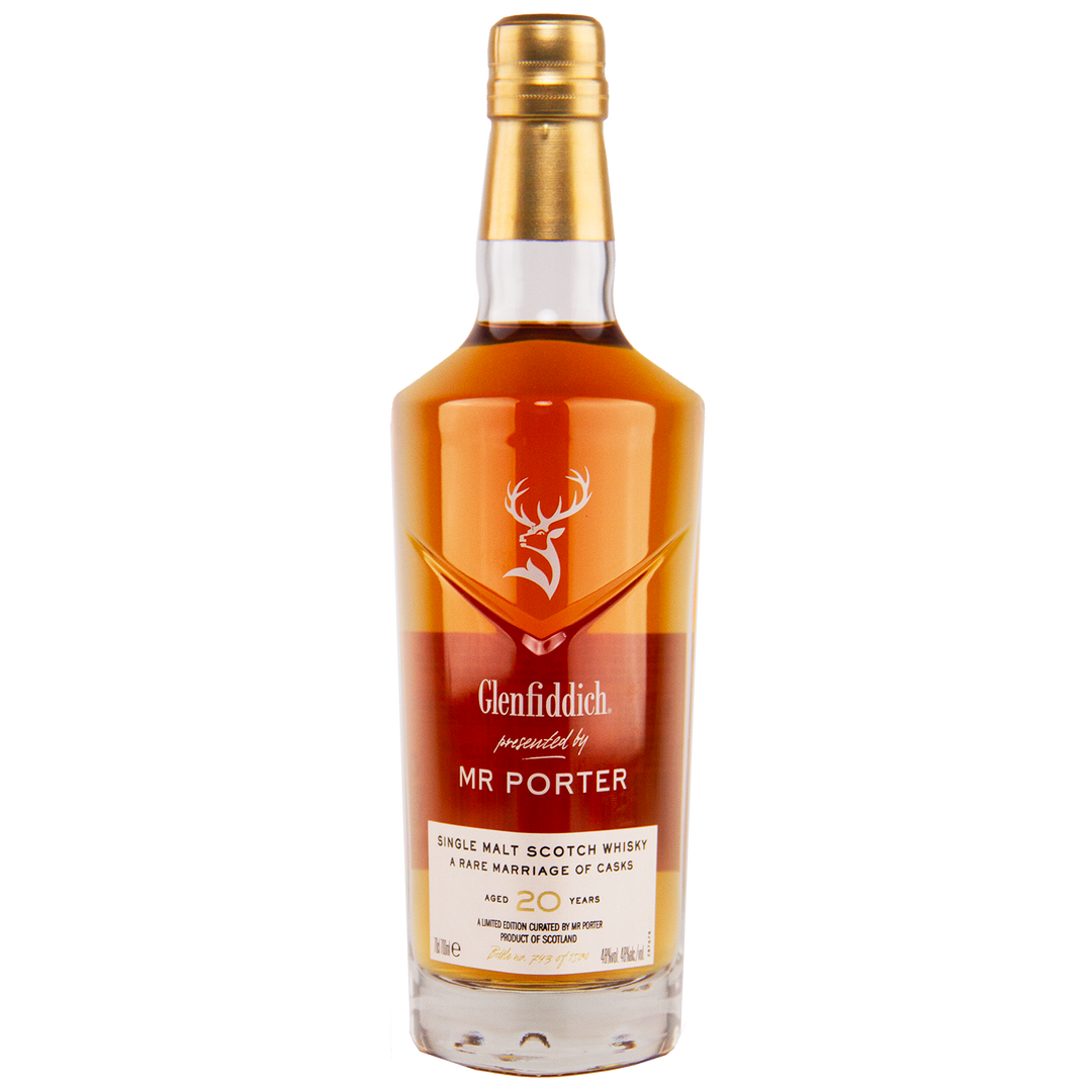 A bottle of Glenfiddich Mr. Porter 20 Year Old Single Malt Scotch Whisky features a golden cap, amber liquid, the stag logo, and “presented by MR PORTER” label, indicating it is a limited edition aged 20 years.
