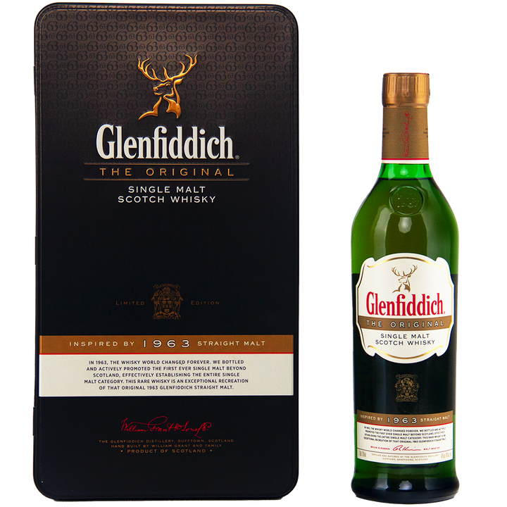 A bottle of Glenfiddich The Original Single Malt Scotch Whisky stands beside its black rectangular box, both adorned with gold and white labels and detailing, featuring "1963 Straight Malt" prominently.