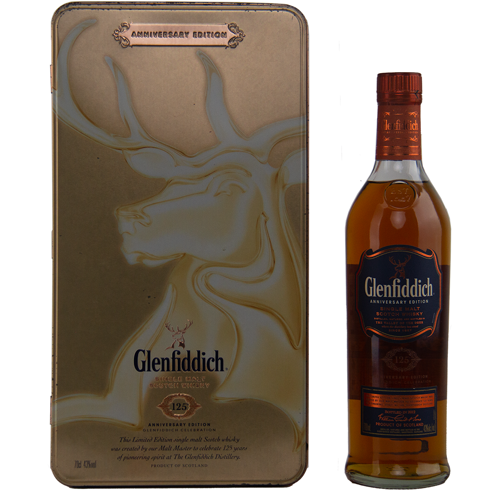 A Glenfiddich 125th Anniversary Edition Single Malt Scotch Whisky bottle stands beside a decorative gold tin adorned with an embossed stag and Glenfiddich branding, matured in European oak casks for added depth.