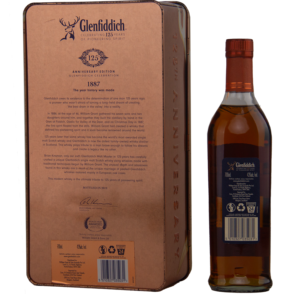 A Glenfiddich 125th Anniversary Edition Single Malt Scotch Whisky bottle is displayed next to its ornate tin box, showcasing detailed branding, distillery history, and notes on European oak cask maturation.