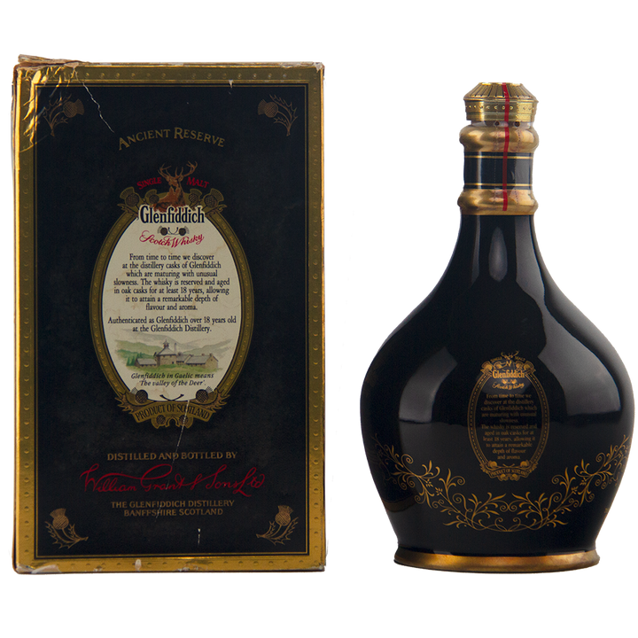 A dark, round Glenfiddich 18 Year Old Ancient Reserve Single Malt Scotch Whisky bottle with gold and red accents stands beside its matching black and gold box featuring elegant text and ornate designs.