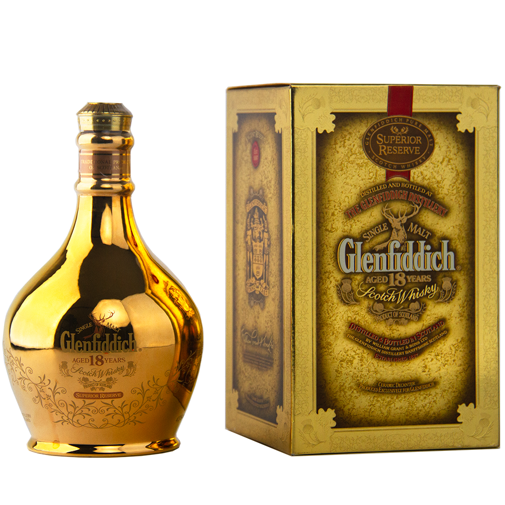 A gold-colored bottle of Glenfiddich 18 Year Old Superior Reserve Single Malt Scotch Whisky stands beside its ornate gold and brown box, both adorned with designs and text highlighting the whisky’s age and superior quality.