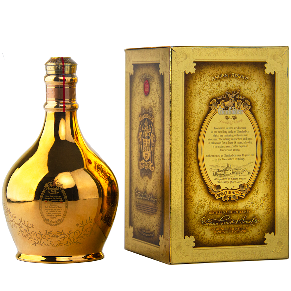 A golden, reflective bottle of Glenfiddich 18 Year Old Superior Reserve Single Malt Scotch Whisky stands by its ornate, gold-accented box adorned with detailed text and decorative designs on a light background.