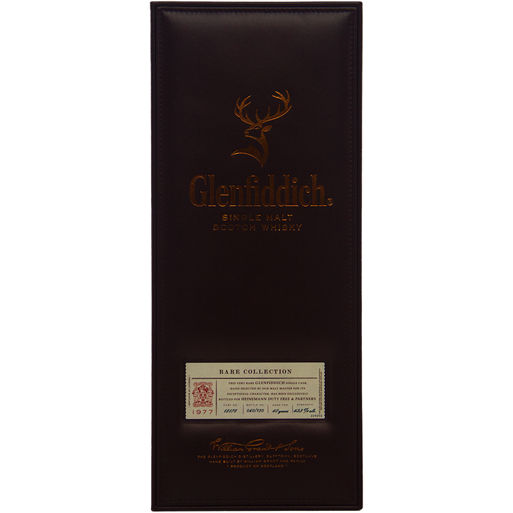 A rectangular Glenfiddich 40 year old 1977 Rare Vintage Single Malt Scotch Whisky box, dark brown with copper lettering and a stag logo, highlights its status as a rare vintage single malt.