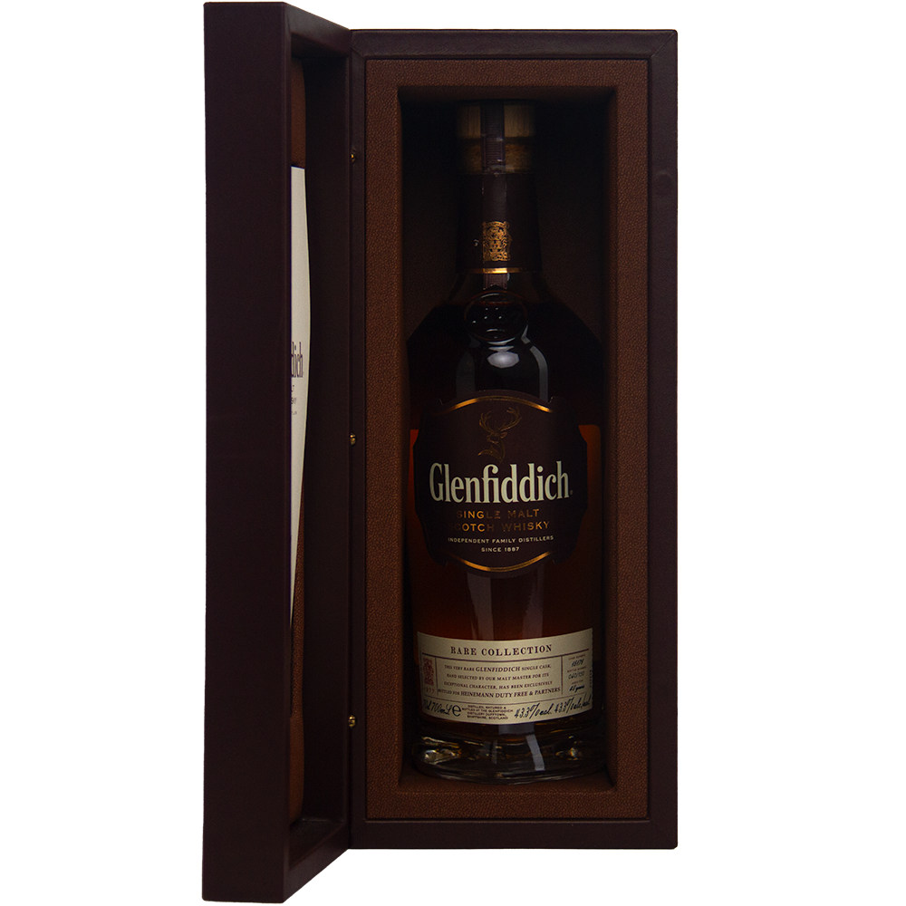 A bottle of Glenfiddich 40 Year Old 1977 Rare Vintage Single Malt Scotch Whisky, displayed upright in an open, padded brown presentation box.