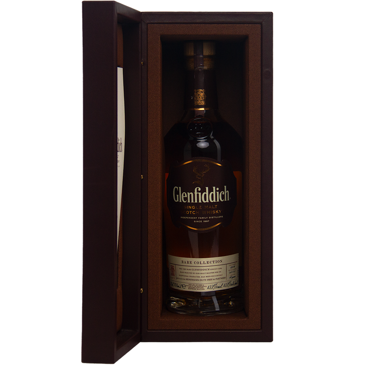 A bottle of Glenfiddich 40 Year Old 1977 Rare Vintage Single Malt Scotch Whisky, displayed upright in an open, padded brown presentation box.