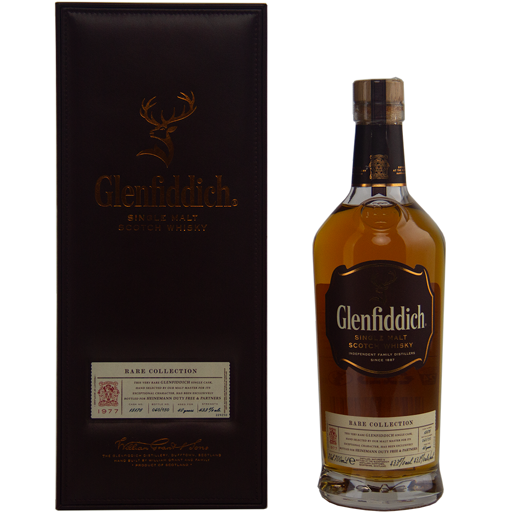 A bottle of Glenfiddich 40 Year Old 1977 Rare Vintage Single Malt Scotch Whisky stands next to its dark brown presentation box, both adorned with gold lettering and detailed labels.