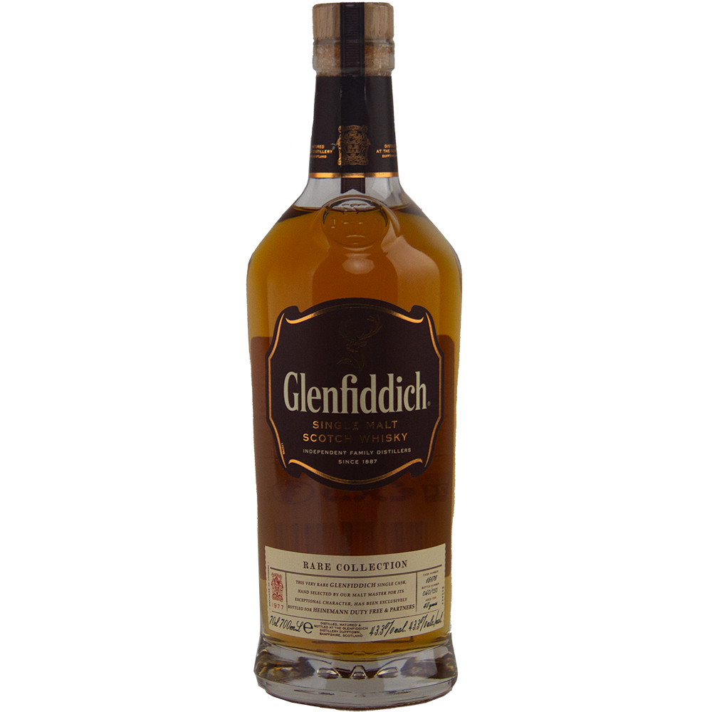 A bottle of Glenfiddich 40 Year Old 1977 Rare Vintage Single Malt Scotch Whisky, a rare single malt featuring a brown label with gold accents and rich amber whisky from a single cask.