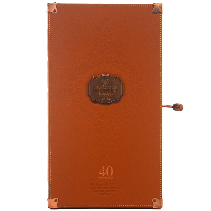 Rectangular brown leather box with embossed designs, copper-colored corners, and a metal plaque reading Glenfiddich 40 Year Old Single Malt Scotch Whisky—a refined case for this limited edition Speyside single malt.